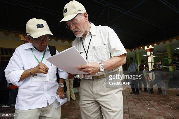 Two election observers from European Union checks progress of elections at a polling center in Banda Aceh on April 9, 2009. Elections in Aceh went...