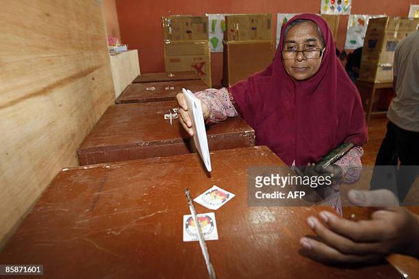 An Acehnese woman casts her ballot at a polling center in Banda Aceh on April 9, 2009. Elections in Aceh went ahead peacefully following the murders...