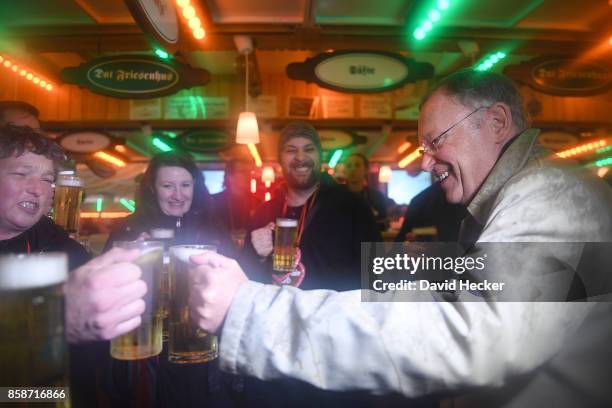 Stephan Weil , German Social Democrat and governor of the state of Lower Saxony, enjoys a drink with party supporters while campaigning in Lower...