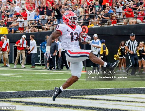 Elijah Holyfield of the Georgia Bulldogs rushes for a touchdown against the Vanderbilt Commodores during the second half at Vanderbilt Stadium on...