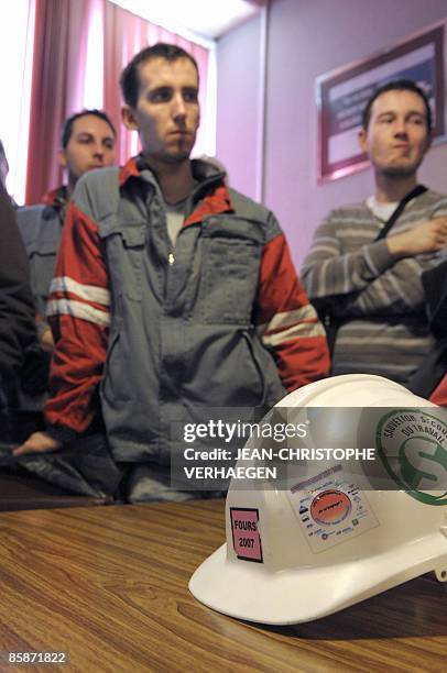 Workers of the steel giant ArcelorMittal wait before a union-management meeting on April 9 at the Florange plant, eastern France. About 300 angry...