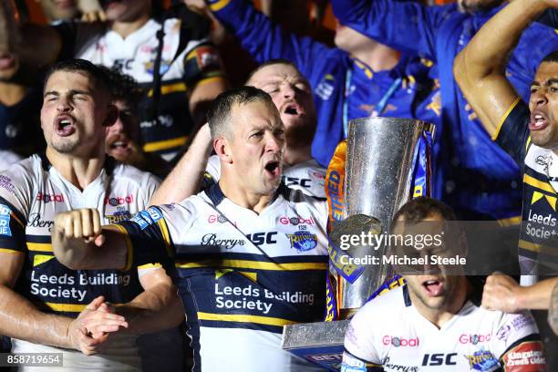 Danny McGuire of Leeds Rhinos celebrates with the trophy and his team-mates at the end of the Betfred Super League Grand Final match between...