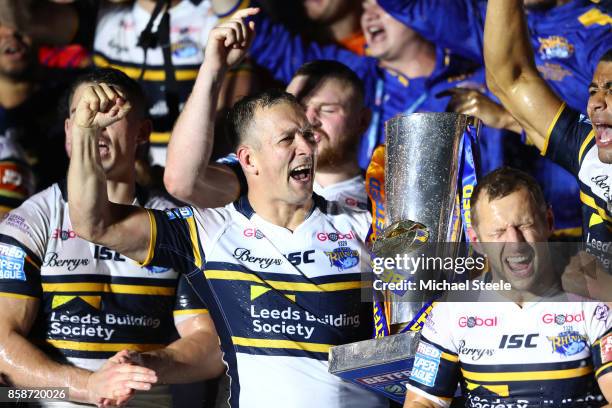 Danny McGuire of Leeds Rhinos celebrates with the trophy and his team-mates at the end of the Betfred Super League Grand Final match between...