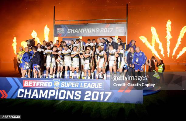 Danny McGuire of Leeds Rhinos lifts the trophy with his team-mates at the end of the Betfred Super League Grand Final match between Castleford Tigers...