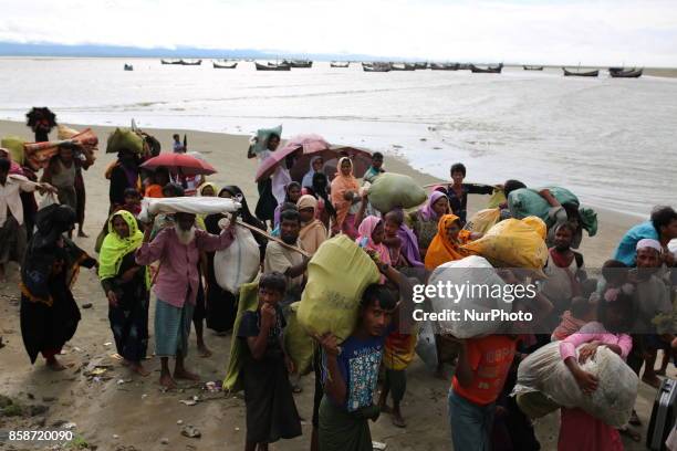 Rohingya people, fled from ongoing military operation in Myanmar Rakhain state, walks along the road at Shah Pori Island to go to refugee camp in...