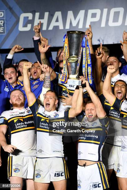 Danny McGuire and Rob Burrow of Leeds Rhinos lift the trophy with their team-mates at the end of the Betfred Super League Grand Final match between...