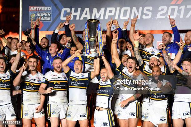 Danny McGuire and Rob Burrow of Leeds Rhinos lift the trophy with their team-mates at the end of the Betfred Super League Grand Final match between...