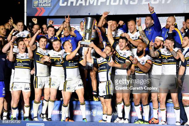 Danny McGuire and Rob Burrow of Leeds Rhinos lift the trophy with their team-mates at the end of the Betfred Super League Grand Final match between...