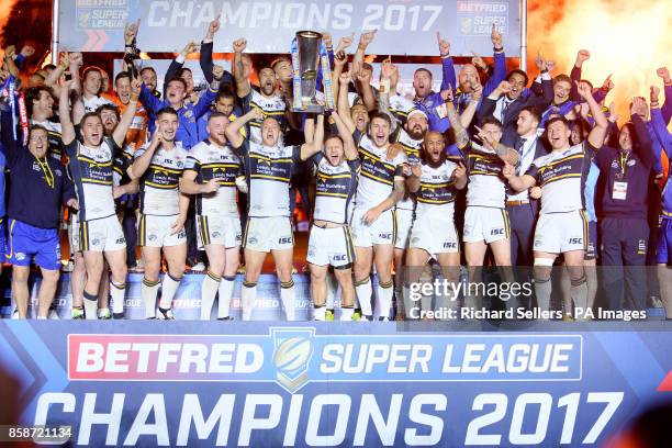 Leeds Rhinos players celebrate with the trophy after the final whistle during the Betfred Super League Grand Final at Old Trafford, Manchester.