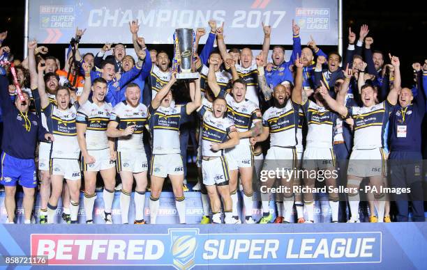 Leeds Rhinos players celebrate with the trophy after the final whistle during the Betfred Super League Grand Final at Old Trafford, Manchester.