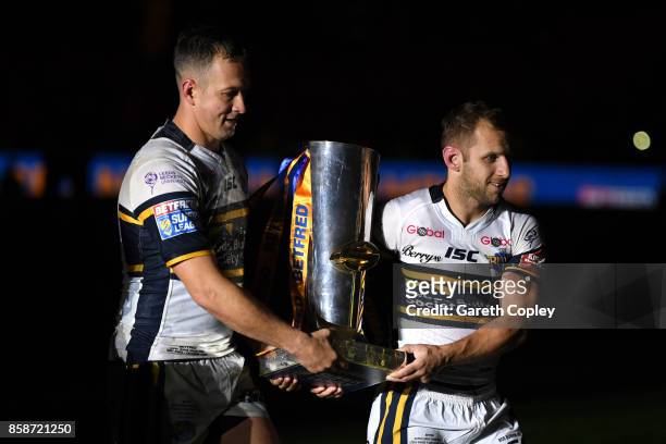 Danny McGuire and Rob Burrow of Leeds Rhinos hold the trophy at the end of the Betfred Super League Grand Final match between Castleford Tigers and...
