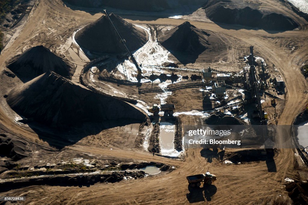Menin Aggregate Mining equipment and vehicles sit at an aggregate mine processing ...