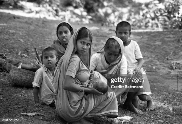 Refugees are shown here arriving along the Jessore-Calcutta road waiting to cross to checkpost at Benapol. As the Pakistani army troops started...