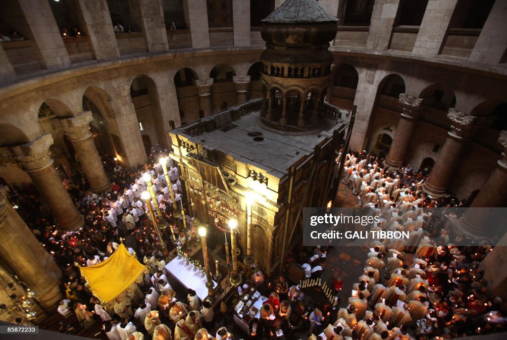 Roman Catholic clergy men hold candles a