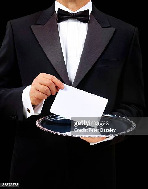 butler with blank card on silver serving tray. - silver platter stock pictures, royalty-free photos & images