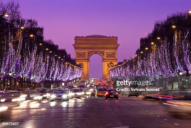 paris, champs-elysees illuminated at chris - arc de triomphe paris stock pictures, royalty-free photos & images