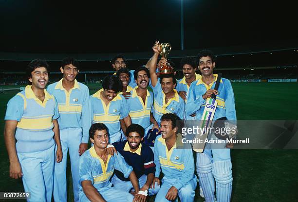 Members of the Indian cricket team with the trophy after their victory over Pakistan in the final of the World Championship of Cricket One Day...
