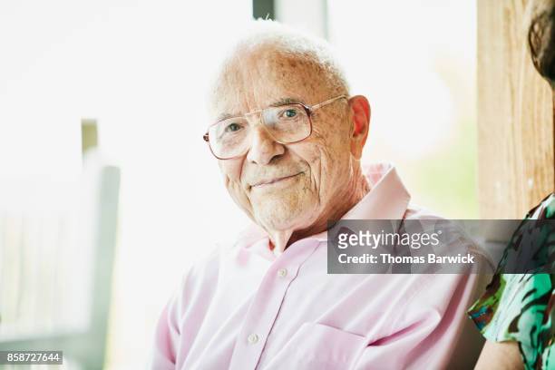 portrait of smiling senior man sitting with friends at dance - mais de 90 anos - fotografias e filmes do acervo