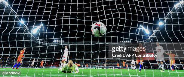 Belarus' goalkeeper Sergei Chernik fails to stop the ball during the FIFA World Cup 2018 qualification football match between Belarus and the...