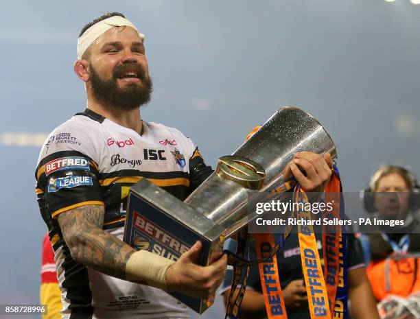 Leeds Rhinos' Adam Cuthbertson celebrates with the trophy after the final whistle during the Betfred Super League Grand Final at Old Trafford,...