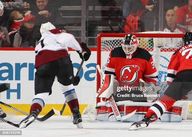 Cory Schneider of the New Jersey Devils makes the second period save on Tyson Jost of the Colorado Avalanche at the Prudential Center on October 7,...