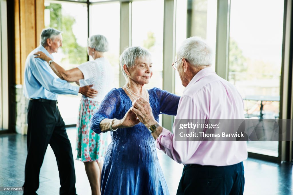 Senior couple dancing together in community center