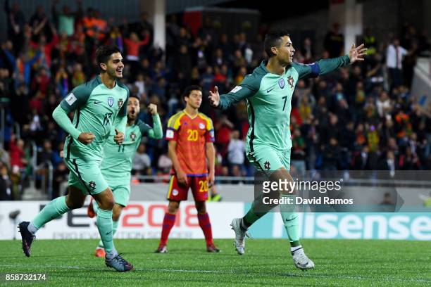Cristiano Ronaldo of Portugal celebrates with his team mate Andre Silva after scoring the opening goal past the goalkeeper Josep Gomes of...