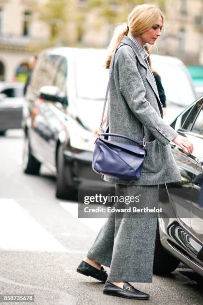 Guest wears gray oversize suit, a blue bag, outside Stella Mccartney, during Paris Fashion Week Womenswear Spring/Summer 2018, on October 2, 2017 in...