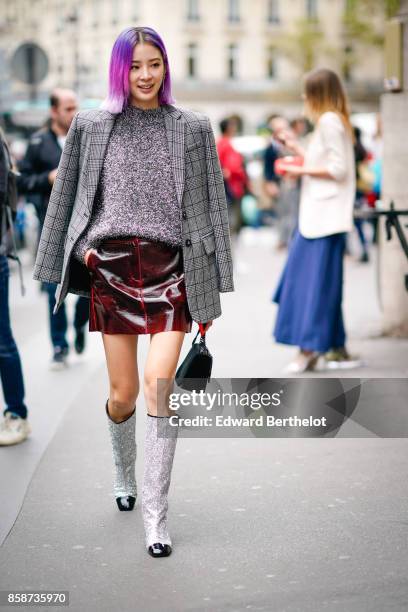 Irene Kim wears a gray tartan blazer jacket, a gray top, a leather skirt, glitter chanel boots, has purple pink hair, outside Stella Mccartney,...