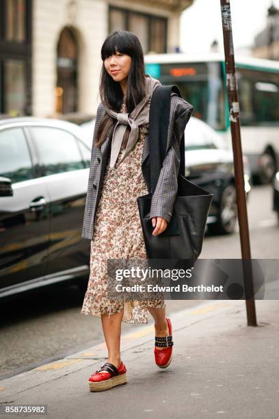 Susie Lau wears a tartan blazer jacket, a scarf, a flower print dress, red shoes, outside Stella Mccartney, during Paris Fashion Week Womenswear...