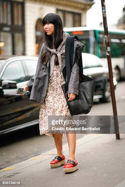 Susie Lau wears a tartan blazer jacket, a scarf, a flower print dress, red shoes, outside Stella Mccartney, during Paris Fashion Week Womenswear...