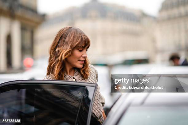 Alexa Chung wears a checkered dress, outside Stella Mccartney, during Paris Fashion Week Womenswear Spring/Summer 2018, on October 2, 2017 in Paris,...