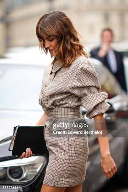 Alexa Chung wears a checkered dress, outside Stella Mccartney, during Paris Fashion Week Womenswear Spring/Summer 2018, on October 2, 2017 in Paris,...