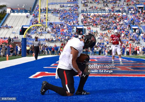 Running back Justin Stockton of the Texas Tech Red Raiders celebrates his touchdown run against the Kansas Jayhawks in the first quarter at Memorial...