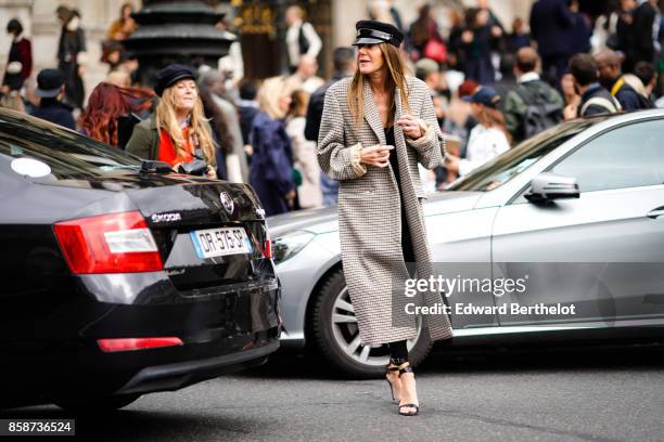 Anna Dello Russo wears a beret hat, a coat, heels, outside Stella Mccartney, during Paris Fashion Week Womenswear Spring/Summer 2018, on October 2,...