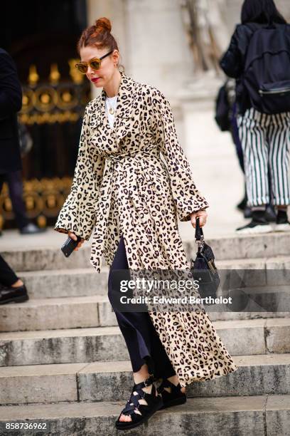 Guest wears a leopard print coat, outside Stella Mccartney, during Paris Fashion Week Womenswear Spring/Summer 2018, on October 2, 2017 in Paris,...