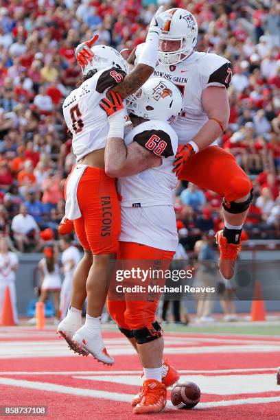 Matthew Wilcox Jr. #6 of the Bowling Green Falcons celebrates with Tim Blair and Tim McAuliffe after scoring a touchdown against the Miami Ohio...