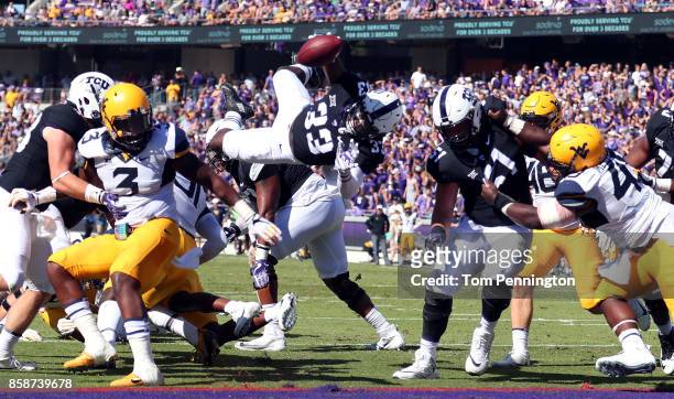 Sewo Olonilua of the TCU Horned Frogs dives into the end zone to score a touchdown against the West Virginia Mountaineers in the first half at Amon...