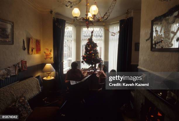 Loyalist woman sitting with her son in the living room of their home on the Shankill Road in west Belfast, Northern Ireland on Christmas day, 1994....