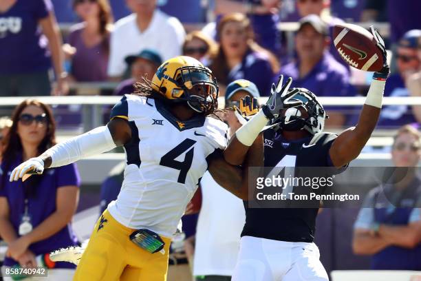 Isaiah Graham of the TCU Horned Frogs goes up for a pass against Mike Daniels Jr. #4 of the West Virginia Mountaineers in the first half at Amon G....