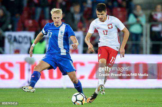 Mikael Soisalo of Finland and Bartosz Kapustka of Poland during the 2019 UEFA European Under-21 Championship qualification game between Poland and...