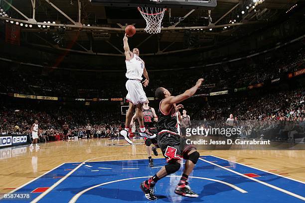 Andre Iguodala of the Philadelphia 76ers goes for a dunk over Derrick Rose of the Chicago Bulls during the game on March 13, 2009 at the Wachovia...