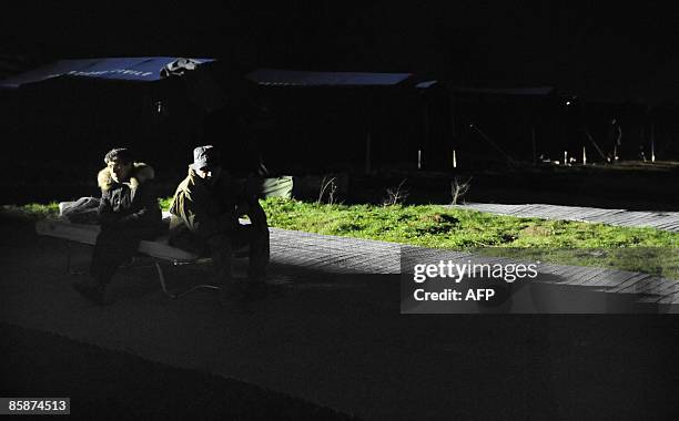 Evacuated people prepare to spend the night in tents in the village of Santa Rufina of Rojo, 12 km from L'Aquila on April 7, 2009. Strong aftershocks...