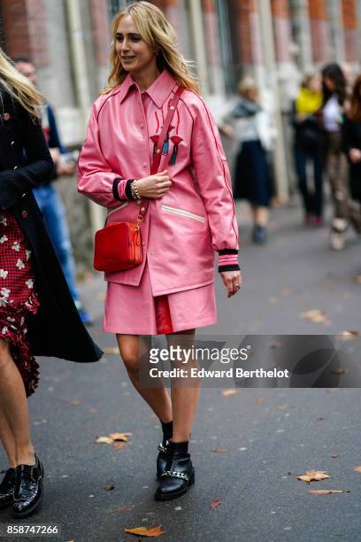 Guest wears a pink shirt, a pink skirt, black shoes , outside Valentino, during Paris Fashion Week Womenswear Spring/Summer 2018, on October 1, 2017...