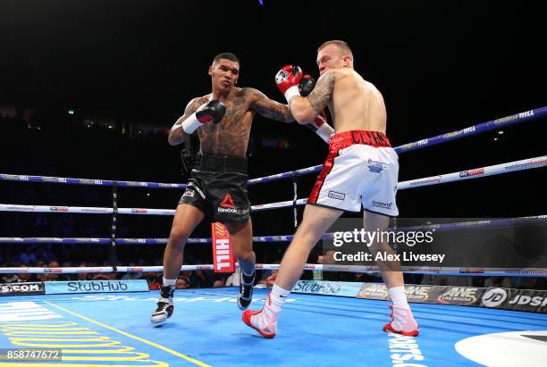 Conor Benn knocks down Nathan Clarke for the second time during the Welterweight Championship fight at Manchester Arena on October 7, 2017 in...