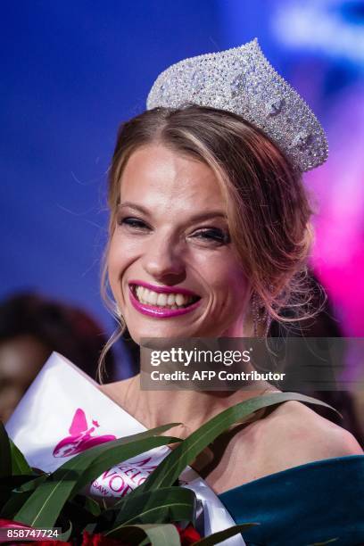 Miss Belarus Aleksandra Chichikova reacts after winning the Miss Wheelchair World contest beauty pageant in Warsaw, on October 7, 2017. The Miss...