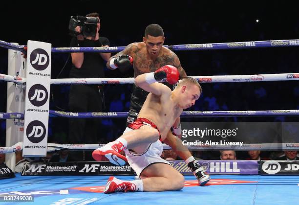 Conor Benn knocks down Nathan Clarke for the first time during the Welterweight Championship fight at Manchester Arena on October 7, 2017 in...