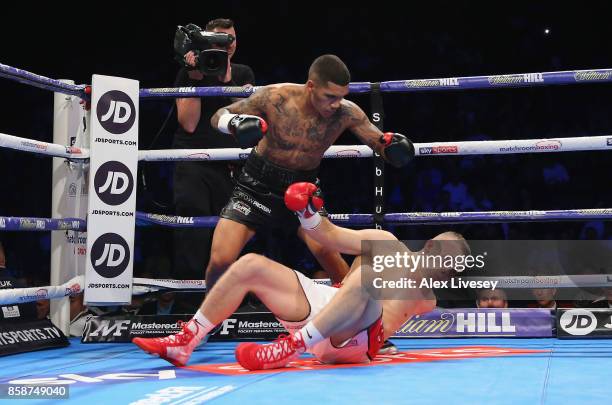 Conor Benn knocks down Nathan Clarke for the first time during the Welterweight Championship fight at Manchester Arena on October 7, 2017 in...