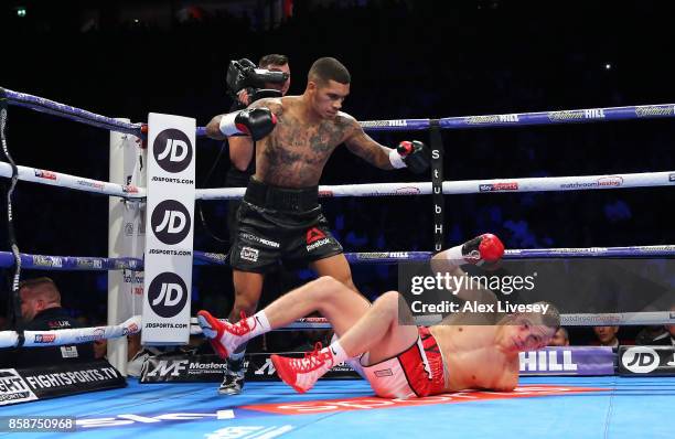 Conor Benn knocks down Nathan Clarke for the first time during the Welterweight Championship fight at Manchester Arena on October 7, 2017 in...