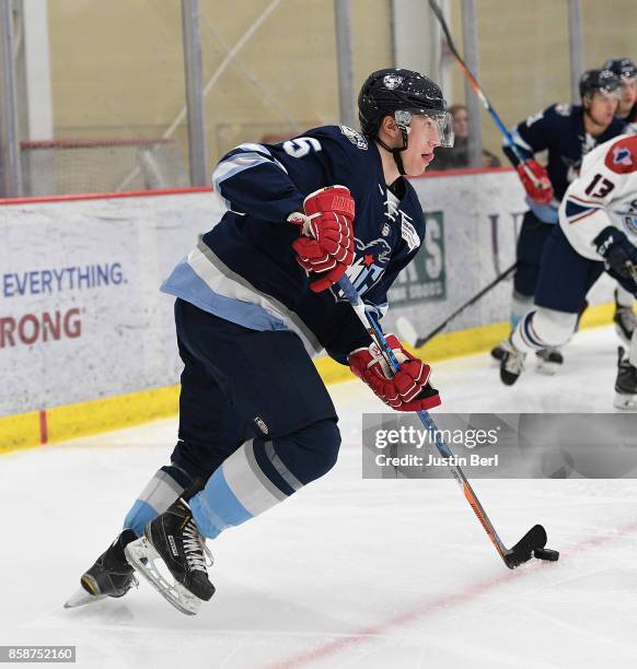 Michael Schumacher of the Madison Capitols skates with the puck in the first period during the game against the Central Illinois Flying Aces on Day 3...